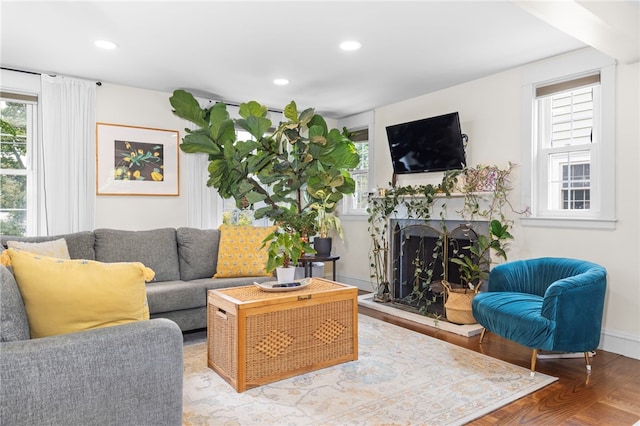 405 Eaton St, Providence, RI 02908 - living area with healthy amount of natural light, a fireplace with raised hearth, wood finished floors, and recessed lighting