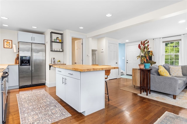 405 Eaton St, Providence, RI 02908 - kitchen with built in fridge, butcher block countertops, a breakfast bar, dark wood-type flooring, and a kitchen island