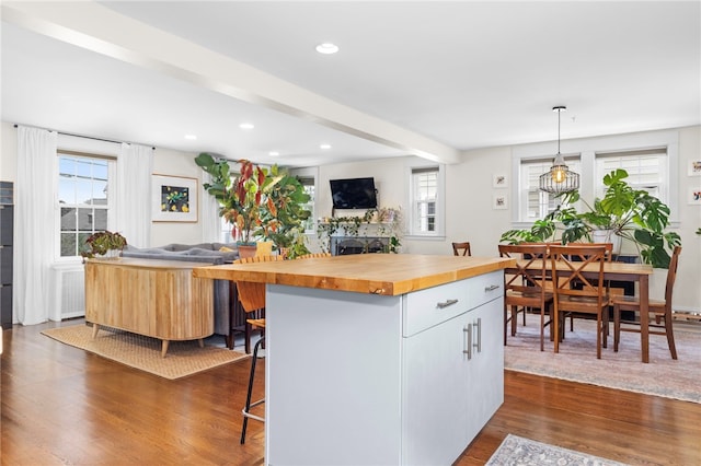 405 Eaton St, Providence, RI 02908 - kitchen featuring wood counters, dark wood-style floors, a breakfast bar, open floor plan, and recessed lighting