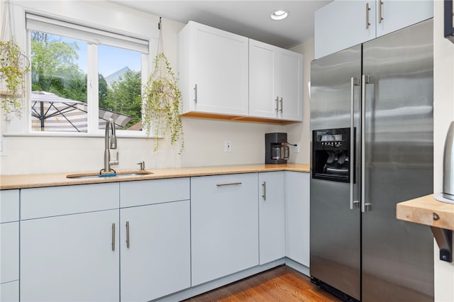 405 Eaton St, Providence, RI 02908 - kitchen with high end refrigerator, a sink, light countertops, white cabinetry, and wood finished floors