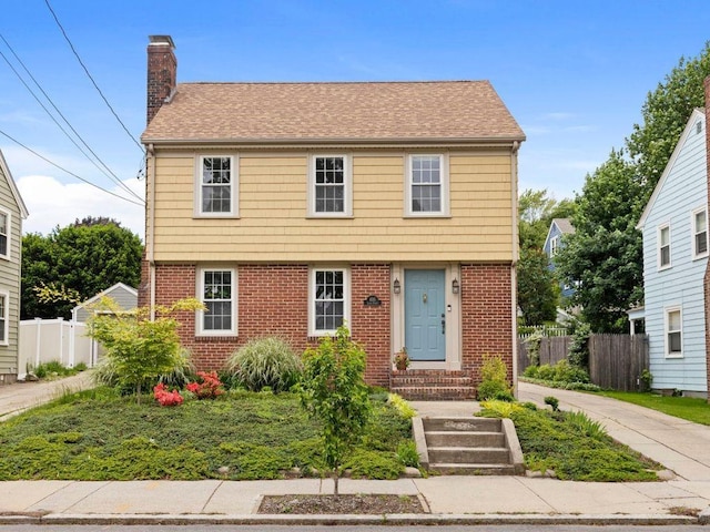 405 Eaton St, Providence, RI 02908 - colonial inspired home featuring brick siding, a chimney, and roof with shingles