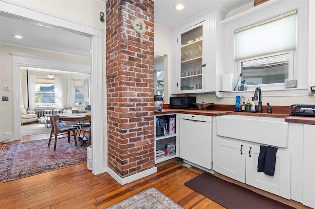 143 Ivy St, Providence, RI 02906 - kitchen featuring butcher block counters, white dishwasher, a sink, wood finished floors, and white cabinets
