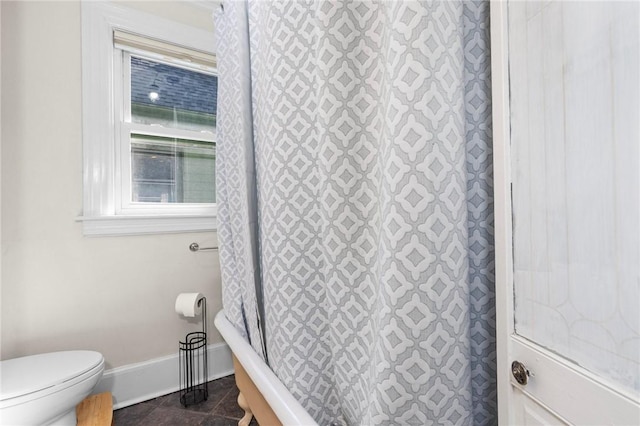 143 Ivy St, Providence, RI 02906 - bathroom with baseboards, toilet, and tile patterned floors