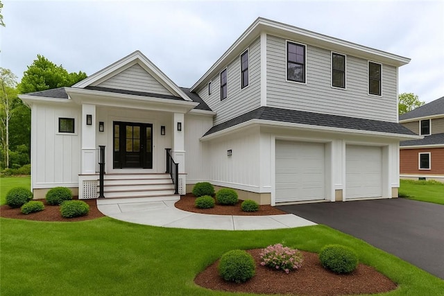 68 Orchard Ave, Johnston, RI 02919 - view of front of home featuring an attached garage, a front lawn, driveway, and board and batten siding