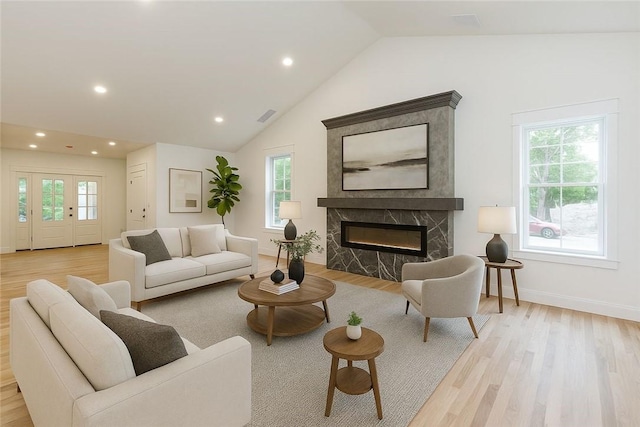 68 Orchard Ave, Johnston, RI 02919 - living room with light wood-type flooring, vaulted ceiling, recessed lighting, a premium fireplace, and baseboards