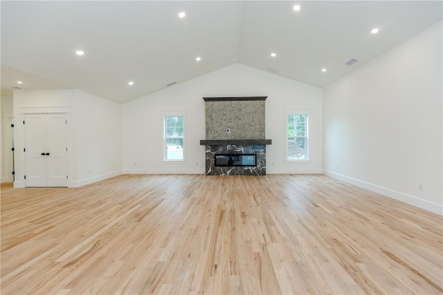 68 Orchard Ave, Johnston, RI 02919 - unfurnished living room featuring a glass covered fireplace, light wood-style flooring, healthy amount of natural light, lofted ceiling, and baseboards