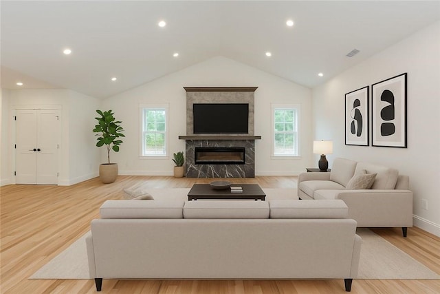 68 Orchard Ave, Johnston, RI 02919 - living room with light wood finished floors, baseboards, vaulted ceiling, a high end fireplace, and recessed lighting