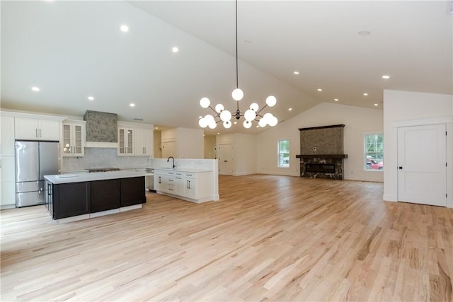 68 Orchard Ave, Johnston, RI 02919 - kitchen with stainless steel appliances, a center island, a sink, open floor plan, and light countertops