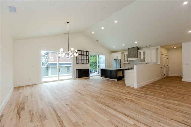 68 Orchard Ave, Johnston, RI 02919 - kitchen with freestanding refrigerator, open floor plan, a center island, white cabinets, and light wood finished floors