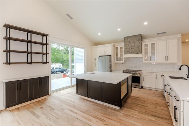 68 Orchard Ave, Johnston, RI 02919 - kitchen featuring appliances with stainless steel finishes, a sink, wall chimney exhaust hood, light countertops, and decorative backsplash