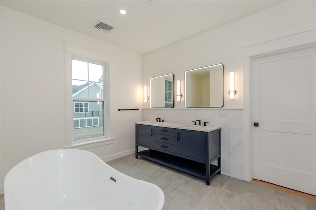 68 Orchard Ave, Johnston, RI 02919 - bathroom with a freestanding tub, double vanity, recessed lighting, and baseboards