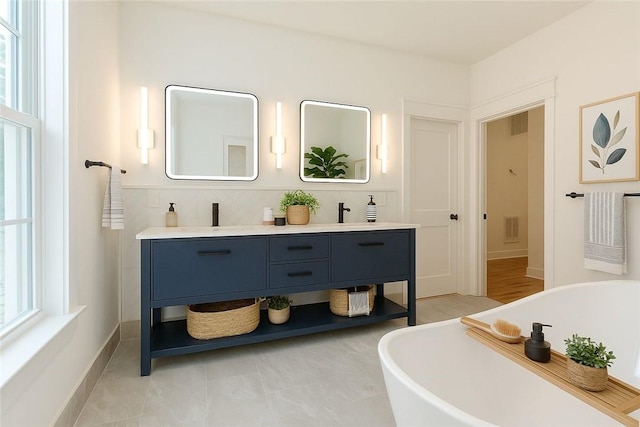 68 Orchard Ave, Johnston, RI 02919 - bathroom featuring double vanity, a freestanding bath, and baseboards
