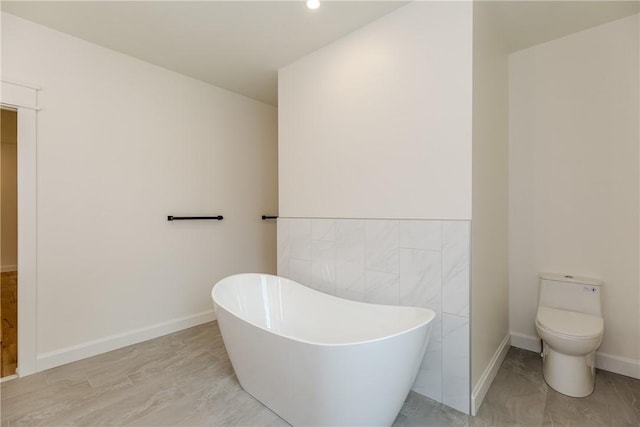 68 Orchard Ave, Johnston, RI 02919 - bathroom with a freestanding tub, toilet, baseboards, recessed lighting, and marble finish flooring