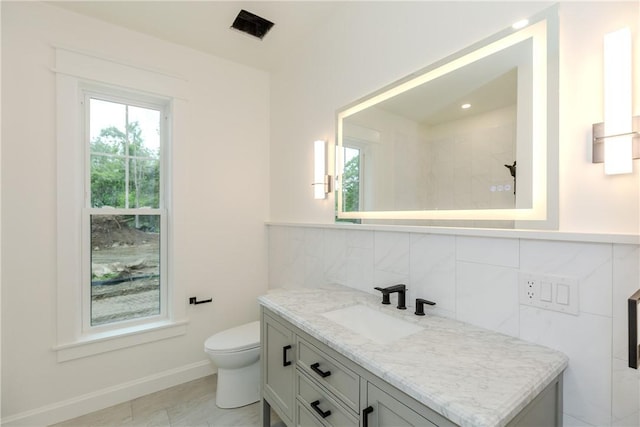 68 Orchard Ave, Johnston, RI 02919 - bathroom with vanity, toilet, baseboards, and tasteful backsplash