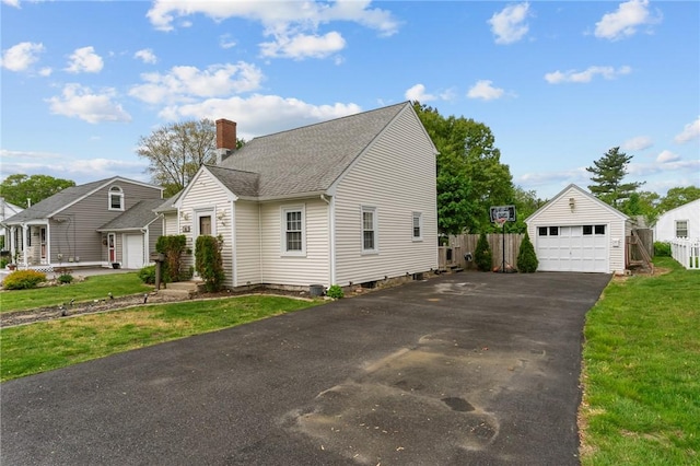 95 George Arden Ave, Warwick, RI 02886 - view of front of home with a detached garage, a chimney, a shingled roof, and an outbuilding