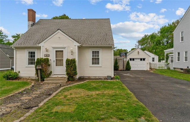 95 George Arden Ave, Warwick, RI 02886 - view of front of property featuring a garage, an outdoor structure, a chimney, and a shingled roof