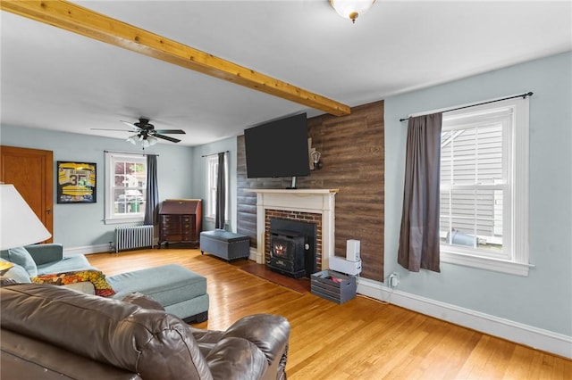 95 George Arden Ave, Warwick, RI 02886 - living area featuring radiator, baseboards, light wood finished floors, and beamed ceiling