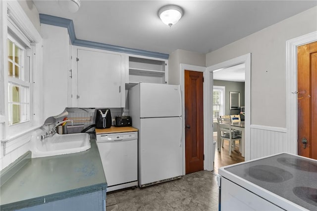 95 George Arden Ave, Warwick, RI 02886 - kitchen with white appliances, a sink, white cabinets, open shelves, and wainscoting
