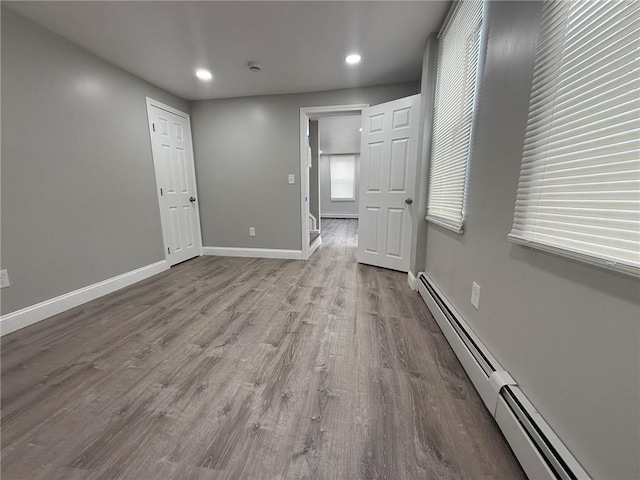 103 Pleasent St, Woonsocket, RI 02895 - spare room featuring baseboard heating, wood finished floors, baseboards, recessed lighting, and a smoke detector