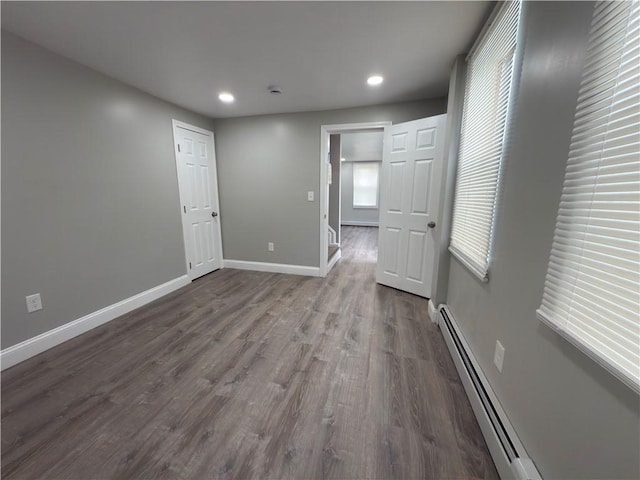 103 Pleasent St, Woonsocket, RI 02895 - spare room with dark wood-type flooring, baseboards, recessed lighting, and a baseboard heating unit