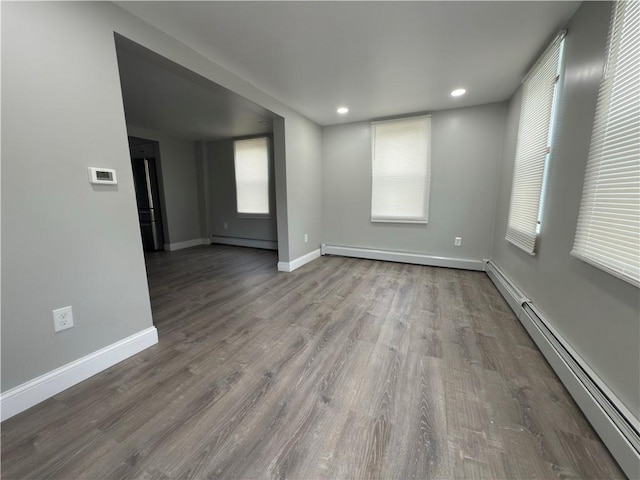 103 Pleasent St, Woonsocket, RI 02895 - spare room featuring baseboard heating, baseboards, wood finished floors, and recessed lighting