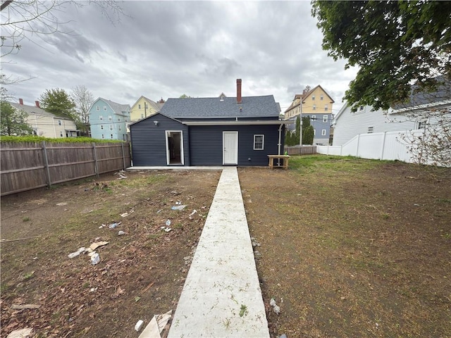 103 Pleasent St, Woonsocket, RI 02895 - back of house featuring a fenced backyard and a residential view