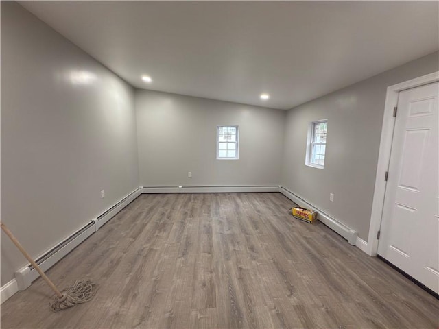 103 Pleasent St, Woonsocket, RI 02895 - empty room with wood finished floors, baseboards, recessed lighting, and baseboard heating