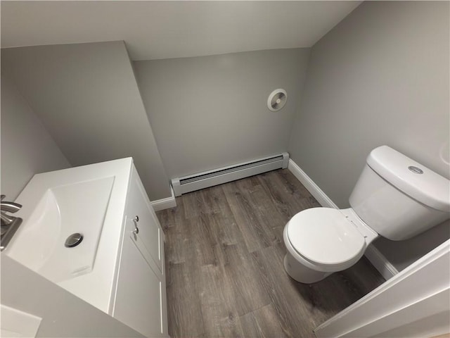 103 Pleasent St, Woonsocket, RI 02895 - half bath featuring baseboard heating, toilet, wood finished floors, vanity, and baseboards