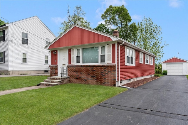 20 Loxley Rd, Providence, RI 02908 - bungalow-style house featuring a garage, a front yard, a chimney, an outdoor structure, and brick siding