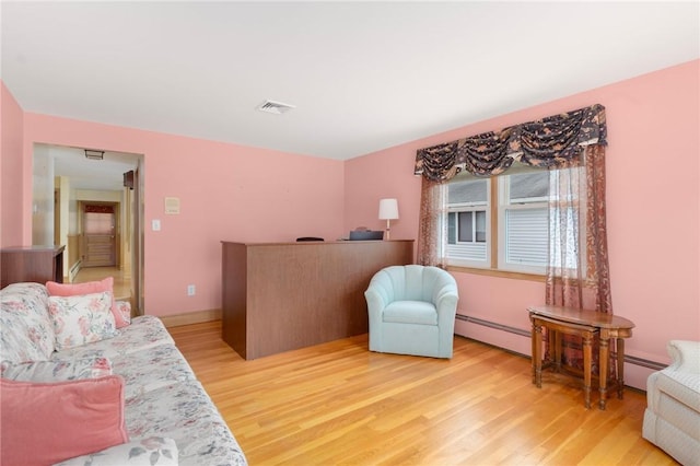 20 Loxley Rd, Providence, RI 02908 - living area with light wood-style floors and baseboard heating