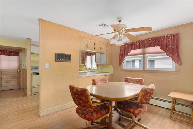 20 Loxley Rd, Providence, RI 02908 - dining space featuring light wood finished floors, baseboard heating, ceiling fan, and baseboards