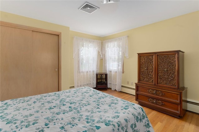 20 Loxley Rd, Providence, RI 02908 - bedroom with light wood-style floors, a baseboard radiator, and a closet