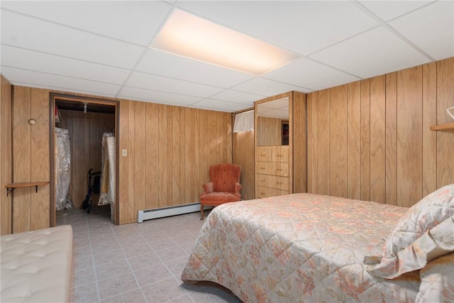 20 Loxley Rd, Providence, RI 02908 - bedroom featuring a baseboard radiator, wood walls, and a paneled ceiling
