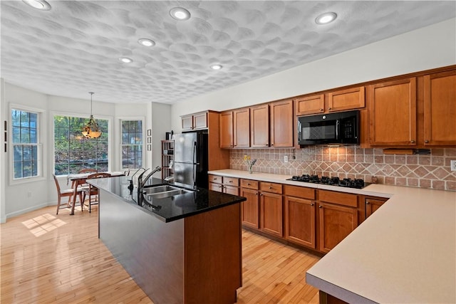 32 Trolley Ln, Westerly, RI 02891 - kitchen featuring black appliances, a sink, brown cabinets, backsplash, and recessed lighting