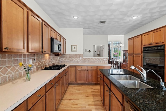 32 Trolley Ln, Westerly, RI 02891 - kitchen with black appliances, a sink, brown cabinetry, light wood-style flooring, and recessed lighting