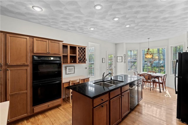 32 Trolley Ln, Westerly, RI 02891 - kitchen featuring black appliances, a sink, brown cabinetry, open shelves, and a center island with sink