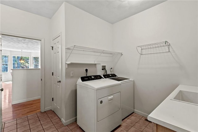 32 Trolley Ln, Westerly, RI 02891 - washroom with separate washer and dryer, light tile patterned flooring, and baseboards