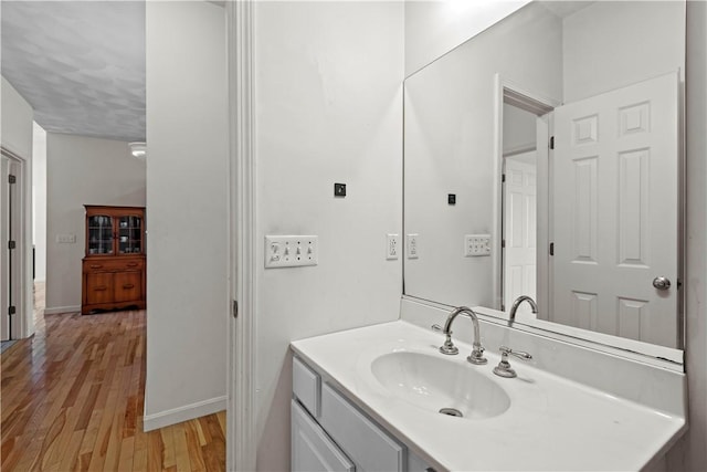 32 Trolley Ln, Westerly, RI 02891 - bathroom with wood finished floors, vanity, and baseboards