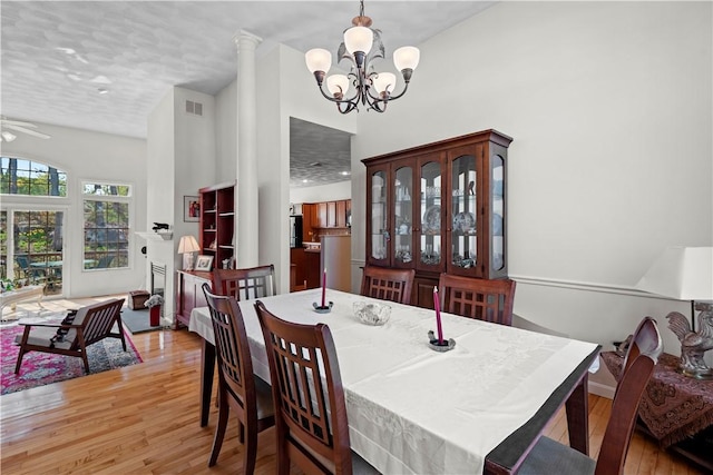 32 Trolley Ln, Westerly, RI 02891 - dining area featuring wood-type flooring, a chandelier, a ceiling fan, and a high ceiling