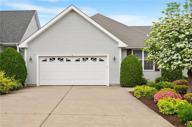 5 Enzo Dr, Coventry, RI 02816 - view of front facade featuring a garage, roof with shingles, and concrete driveway