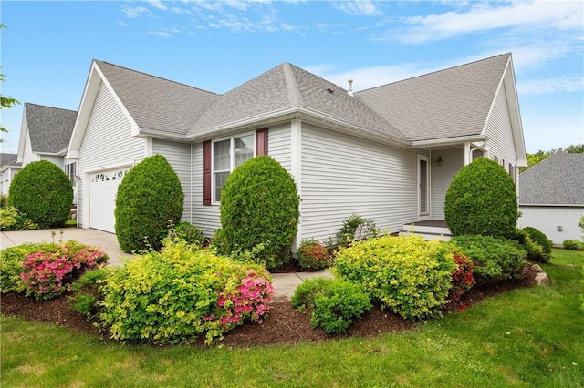5 Enzo Dr, Coventry, RI 02816 - view of side of property with an attached garage, a shingled roof, and concrete driveway