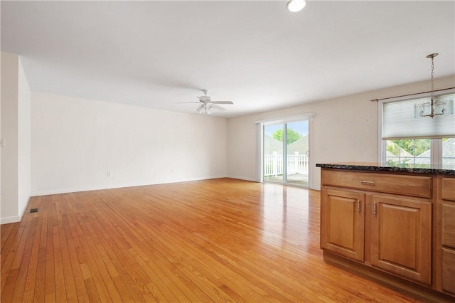 5 Enzo Dr, Coventry, RI 02816 - unfurnished living room with light wood-type flooring, ceiling fan, a chandelier, and baseboards