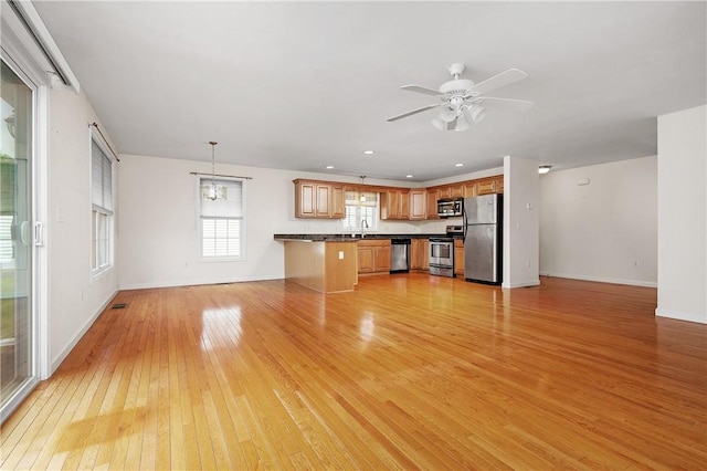 5 Enzo Dr, Coventry, RI 02816 - unfurnished living room featuring a sink, light wood finished floors, baseboards, and ceiling fan