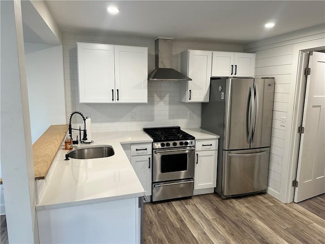 111 Samuel Gorton Ave, Warwick, RI 02889 - kitchen featuring wall chimney range hood, appliances with stainless steel finishes, a sink, dark wood finished floors, and recessed lighting