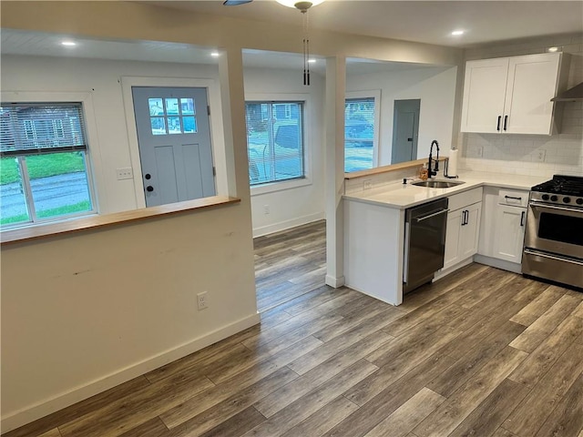111 Samuel Gorton Ave, Warwick, RI 02889 - kitchen with dishwasher, a sink, stainless steel gas stove, dark wood-style floors, and white cabinetry