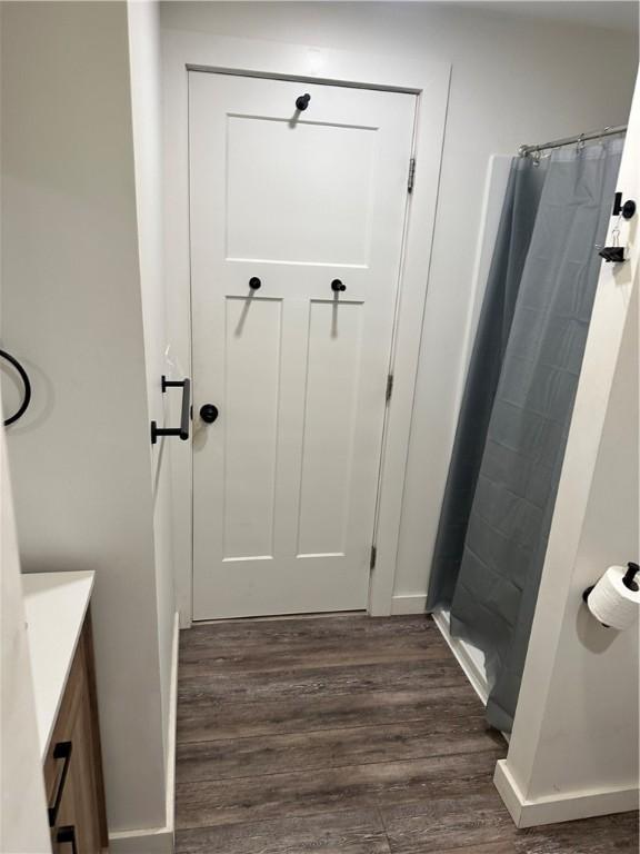 111 Samuel Gorton Ave, Warwick, RI 02889 - full bath featuring vanity, wood finished floors, and a tile shower