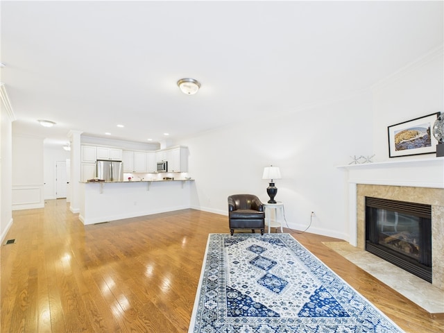 147 Southwinds Dr, South Kingstown, RI 02879 - living room featuring ornamental molding, a tile fireplace, baseboards, light wood-style floors, and recessed lighting