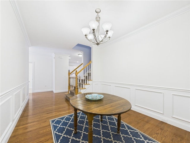 147 Southwinds Dr, South Kingstown, RI 02879 - dining area with stairs, a chandelier, wood finished floors, ornamental molding, and a decorative wall