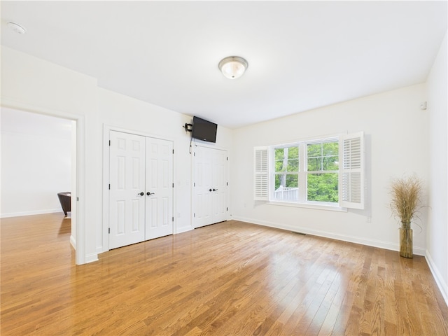 147 Southwinds Dr, South Kingstown, RI 02879 - unfurnished bedroom featuring light wood finished floors, multiple closets, and baseboards