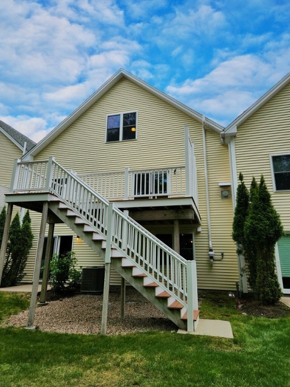 147 Southwinds Dr, South Kingstown, RI 02879 - rear view of house featuring stairway, a yard, a wooden deck, and central air condition unit